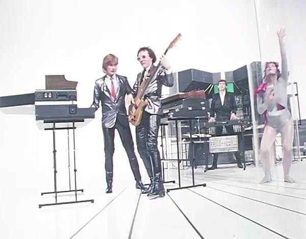 musicians in a white studio playing instruments