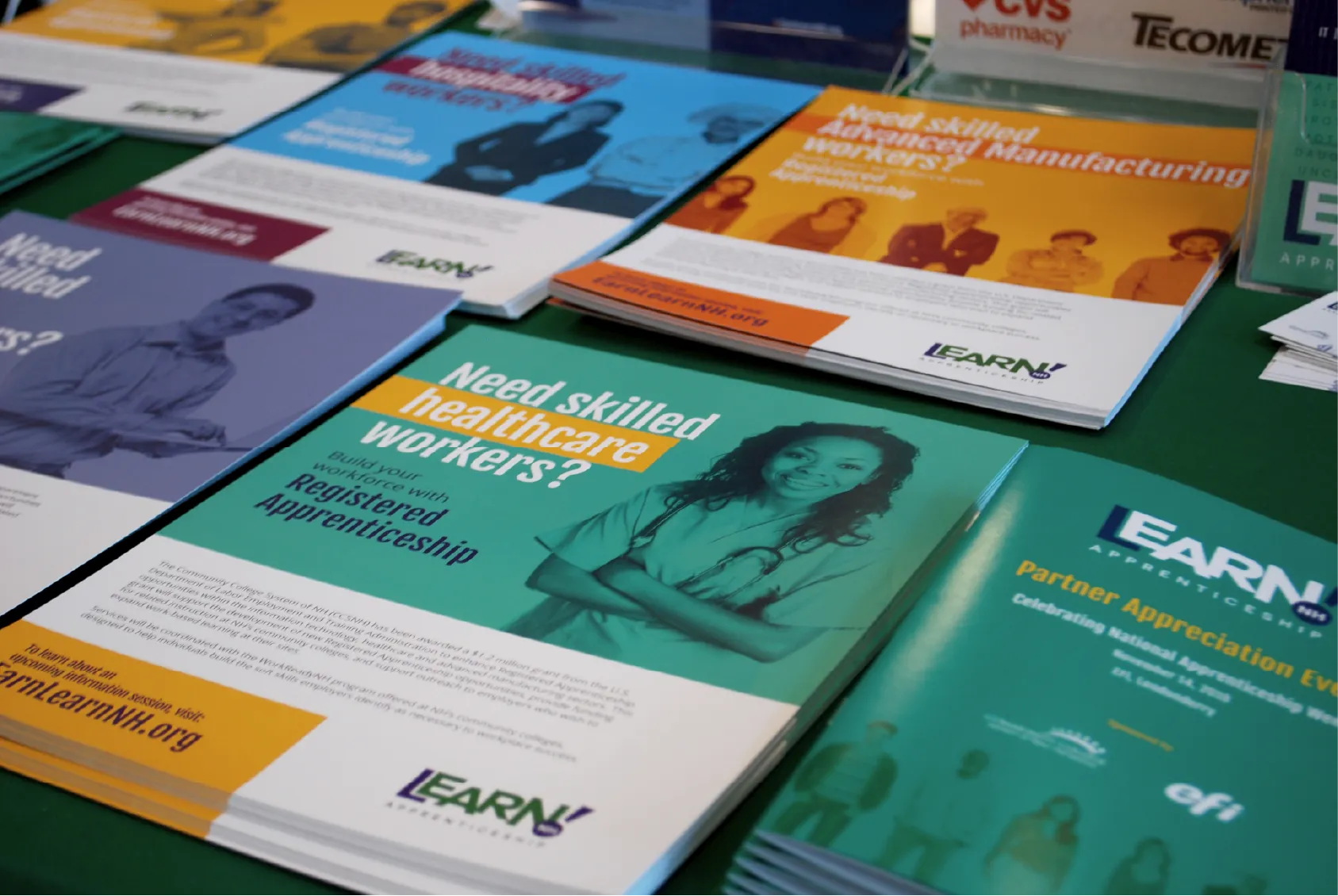 Brochures on a table promoting apprentice programs, including one for skilled healthcare workers.