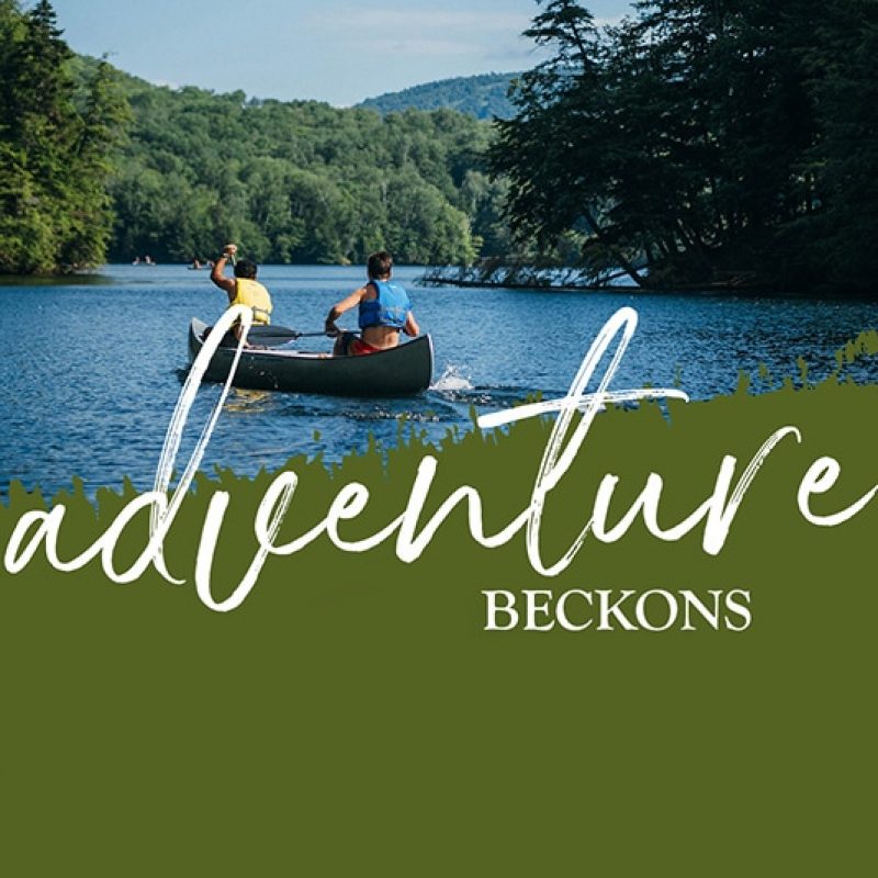 Two people canoeing on a lake surrounded by trees, with "adventure beckons" overlaid&mdash;a perfect visual for marketing campaigns that inspire exploration and connection with nature.