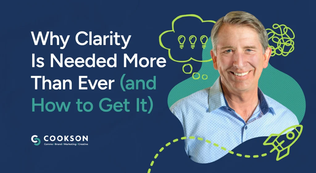 Smiling man with text: Why Clarity Is Needed More Than Ever (and How to Get It) on a blue background.
